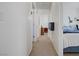 Hallway leading to bedrooms with neutral carpet and white walls at 9157 Acclamation Ct, Las Vegas, NV 89149