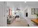 Bright living room with modern ceiling fan, gray sofa, and neutral-toned carpet at 9157 Acclamation Ct, Las Vegas, NV 89149