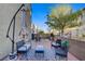 Outdoor patio featuring stylish seating, a shade umbrella, and a grill at 9157 Acclamation Ct, Las Vegas, NV 89149