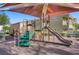 Community playground with slides, stairs, and a shade cover, set amongst residential buildings at 9157 Acclamation Ct, Las Vegas, NV 89149