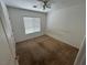 This bedroom has a ceiling fan, neutral walls, and lots of natural light through a window at 96 Saint Johns Wood Ave, Henderson, NV 89002