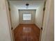This bedroom has hardwood floors, a window, and neutral walls at 96 Saint Johns Wood Ave, Henderson, NV 89002