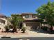 Charming two-story home with a tile roof, mature landscaping, and an attached two-car garage at 96 Saint Johns Wood Ave, Henderson, NV 89002