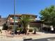 Two-story home with a well-manicured front yard featuring desert landscaping and mature palm trees at 96 Saint Johns Wood Ave, Henderson, NV 89002