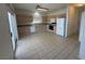 Bright kitchen with tile flooring, oak cabinets, and white appliances, offering a functional space at 96 Saint Johns Wood Ave, Henderson, NV 89002