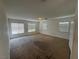 Spacious living room with natural light from multiple windows and a simple ceiling light fixture at 96 Saint Johns Wood Ave, Henderson, NV 89002