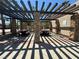 Outdoor community picnic area featuring wooden tables, stone pillars, and a pergola providing shade at 96 Saint Johns Wood Ave, Henderson, NV 89002