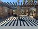 Community picnic area with stone pillars, wooden pergolas, and a picnic table at 96 Saint Johns Wood Ave, Henderson, NV 89002