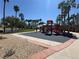 Community playground area with slides, and swings with numerous palm trees and blue skies at 96 Saint Johns Wood Ave, Henderson, NV 89002