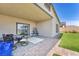 Covered patio has outdoor seating area and meticulously maintained backyard with low-maintenance landscaping, artificial turf, and patio at 10266 Sweet Holly Pl, Las Vegas, NV 89149