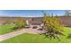 Charming backyard with a paver patio, built-in seating, a fire pit, and artificial turf at 10266 Sweet Holly Pl, Las Vegas, NV 89149