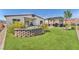 Backyard features artificial turf, a built-in block wall, patio, grill, and lush plants at 10266 Sweet Holly Pl, Las Vegas, NV 89149