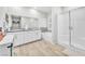 Modern bathroom with double vanity, soaking tub, and separate glass-enclosed shower at 10266 Sweet Holly Pl, Las Vegas, NV 89149