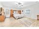 Bright bedroom with hardwood flooring, ceiling fan and a king bed at 10266 Sweet Holly Pl, Las Vegas, NV 89149