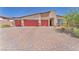 Charming single-story home featuring a three-car garage and brick-paved driveway at 10266 Sweet Holly Pl, Las Vegas, NV 89149