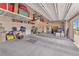 Spacious three-car garage with overhead storage racks and plenty of room for vehicles and storage at 10266 Sweet Holly Pl, Las Vegas, NV 89149
