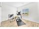 Bright exercise room features wood floors, large window and an exercise machine at 10266 Sweet Holly Pl, Las Vegas, NV 89149