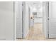 Hallway view leading to modern bathroom with double vanity and soaking tub at 10266 Sweet Holly Pl, Las Vegas, NV 89149
