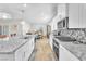 Modern kitchen with granite countertops, stainless steel appliances, and spacious island at 10266 Sweet Holly Pl, Las Vegas, NV 89149