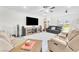 Inviting living room featuring hardwood floors, comfortable seating, and backyard views at 10266 Sweet Holly Pl, Las Vegas, NV 89149