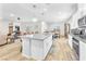 Bright, open-concept kitchen and living area with hardwood floors at 10266 Sweet Holly Pl, Las Vegas, NV 89149