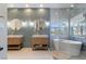 Well lit bathroom featuring dual sinks, large soaking tub, and neutral accent colors at 10729 Grey Havens Ct, Las Vegas, NV 89135