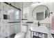 Modern bathroom with geometric tile, floating sink, and a glass enclosed shower at 10729 Grey Havens Ct, Las Vegas, NV 89135