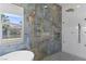 A full bath including a shower, luxurious soaking tub, and a decorative gold ladder at 10729 Grey Havens Ct, Las Vegas, NV 89135