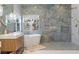 Modern bathroom featuring double vanity, soaking tub, walk-in shower, and stylish tile at 10729 Grey Havens Ct, Las Vegas, NV 89135