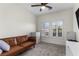 Comfortable bedroom with a brown futon couch, white dresser, and natural light from windows at 10729 Grey Havens Ct, Las Vegas, NV 89135