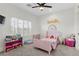 Bright bedroom featuring a pink bed, colorful decor, and a rainbow wall decal at 10729 Grey Havens Ct, Las Vegas, NV 89135
