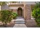 Inviting front entrance with stone accents, a double door entry, and lush landscaping at 10729 Grey Havens Ct, Las Vegas, NV 89135