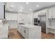 Open kitchen featuring an island, stainless appliances, and custom white cabinets at 10729 Grey Havens Ct, Las Vegas, NV 89135