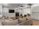 Cozy living room with a fireplace, ceiling fan, and comfortable seating area at 10729 Grey Havens Ct, Las Vegas, NV 89135