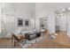Bright, open living room with high ceilings and modern decor, next to the entryway at 10729 Grey Havens Ct, Las Vegas, NV 89135