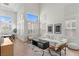 Bright living room featuring large windows with white shutters and modern furniture at 10729 Grey Havens Ct, Las Vegas, NV 89135