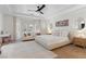 Bright main bedroom with a sitting area, ceiling fan, and French doors to the backyard at 10729 Grey Havens Ct, Las Vegas, NV 89135