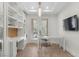 Bright office space with custom built-ins, desk, and French doors leading to the outside at 10729 Grey Havens Ct, Las Vegas, NV 89135