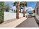 Backyard features palm trees, a privacy wall, a patio, and a dining set at 1116 Piazza Telle, Henderson, NV 89052