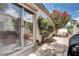 Backyard patio with large sliding door featuring lush greenery and landscape view at 1116 Piazza Telle, Henderson, NV 89052