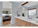 Bright bathroom with double sinks, white countertops, and ensuite bedroom access at 1116 Piazza Telle, Henderson, NV 89052