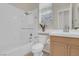 Clean and bright bathroom with a shower-tub combo and a window for natural light, creating a refreshing space at 1116 Piazza Telle, Henderson, NV 89052