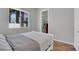 Cozy bedroom featuring hardwood floors, a large window, and a walk-in closet at 1116 Piazza Telle, Henderson, NV 89052