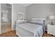 Well-lit bedroom with hardwood floors, a comfortable bed, and ample natural light at 1116 Piazza Telle, Henderson, NV 89052
