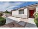 Charming single-story home featuring a red door, manicured landscaping, and inviting walkway at 1116 Piazza Telle, Henderson, NV 89052