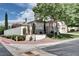 Corner lot home featuring mature trees, manicured landscaping, a white fence, and neutral exterior paint at 1116 Piazza Telle, Henderson, NV 89052