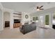 Cozy living room with a fireplace, built-in shelves, and access to the backyard at 1116 Piazza Telle, Henderson, NV 89052