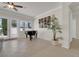 Bright living room featuring a grand piano, tiled floors, and large windows at 1116 Piazza Telle, Henderson, NV 89052