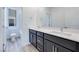 Modern bathroom with double vanity, dark cabinets, and sleek fixtures at 1321 Crimson Sunbird Ave, North Las Vegas, NV 89084