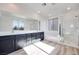 Modern bathroom featuring a double vanity, soaking tub, sleek glass shower, and wood-look tile flooring at 1321 Crimson Sunbird Ave, North Las Vegas, NV 89084